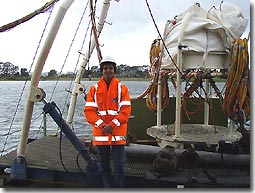This 
  is me, next to the diving bell (used for surface supply diving) on Big Pearl. 
'High viz' clothing, steel capped boots and hard hats were the order 
  of the day.